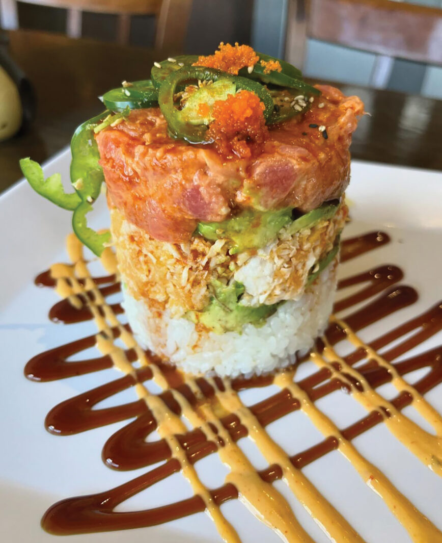 A tuna tower with rice, avocado, tuna and toppings on a plate at Master Joe's in Fairhope, AL.
